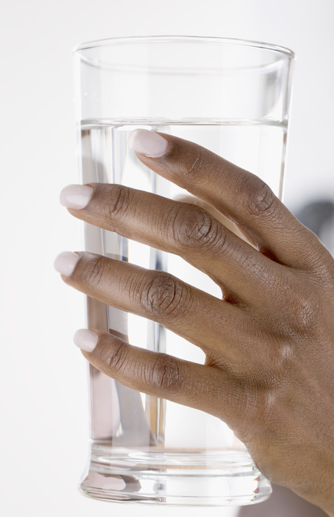 Hand Holding Glass of Water